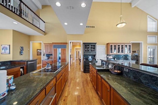 kitchen featuring visible vents, high vaulted ceiling, black electric stovetop, and stainless steel dishwasher