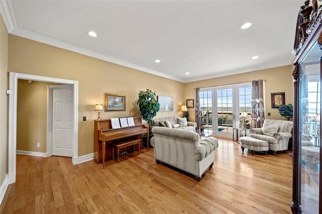 living room featuring recessed lighting, french doors, crown molding, light wood finished floors, and baseboards