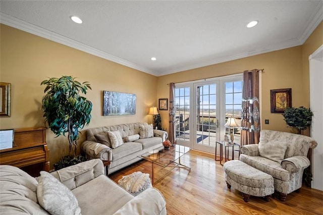 living room featuring recessed lighting, crown molding, and wood finished floors