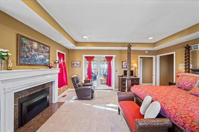 bedroom featuring access to outside, french doors, carpet floors, a fireplace, and baseboards