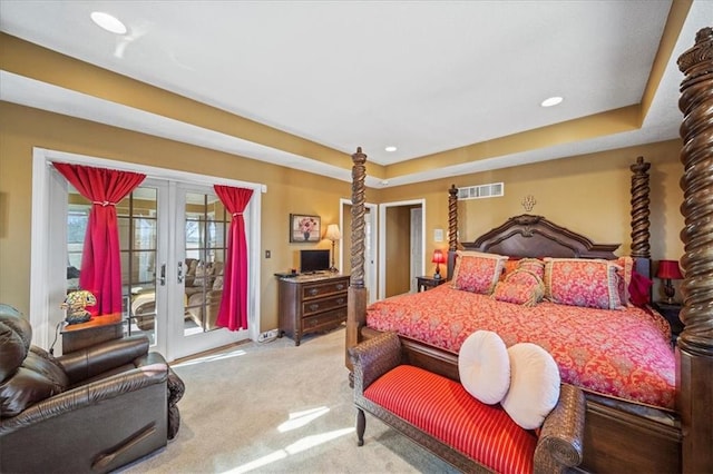 bedroom with visible vents, light carpet, french doors, a raised ceiling, and access to exterior