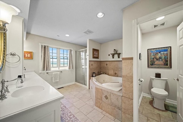 bathroom with a bath, visible vents, a stall shower, a sink, and toilet