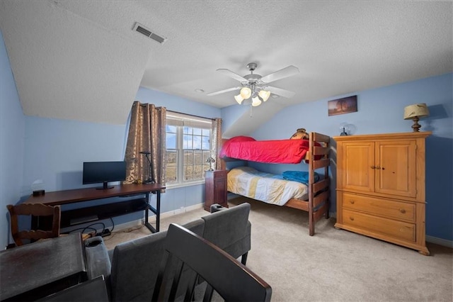 bedroom with visible vents, light carpet, a ceiling fan, a textured ceiling, and lofted ceiling