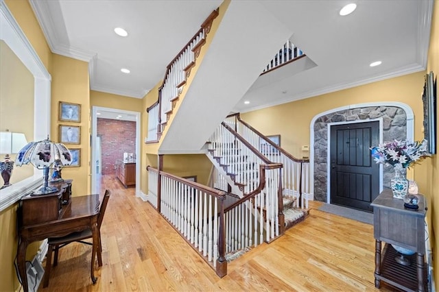 foyer featuring stairway, recessed lighting, wood finished floors, and ornamental molding