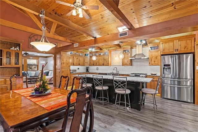 dining space with ceiling fan, wooden ceiling, visible vents, light wood-style floors, and beam ceiling