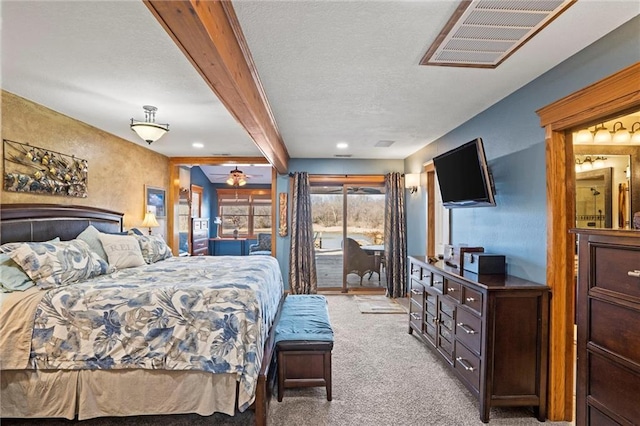 bedroom with access to exterior, beam ceiling, light colored carpet, visible vents, and a textured ceiling