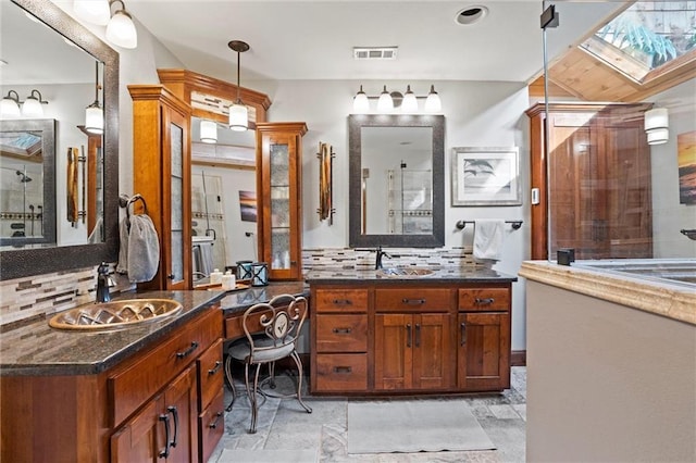 full bathroom with two vanities, visible vents, a sink, and decorative backsplash