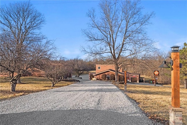 view of street with gravel driveway