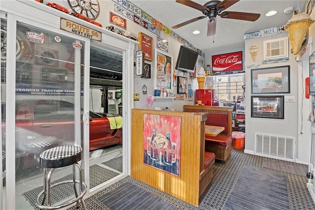 interior space featuring ceiling fan and visible vents