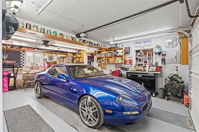 garage with a workshop area and a garage door opener