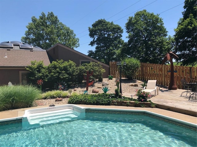 view of pool featuring a fenced in pool, fence, and a deck