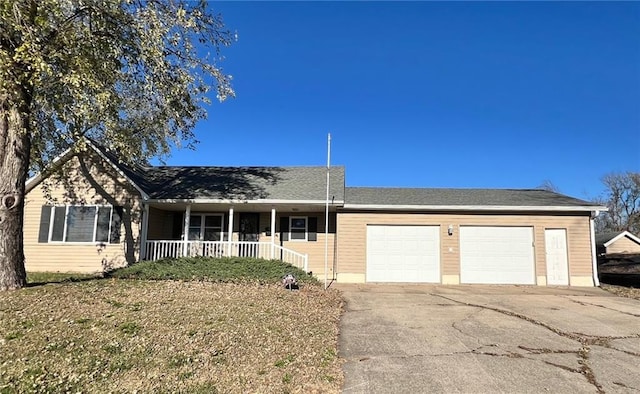 ranch-style home with a garage, covered porch, and driveway