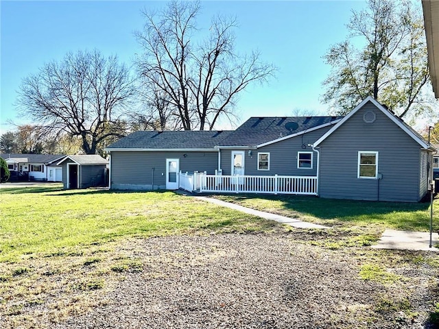 view of front of home with an outbuilding, fence, a front lawn, and a shed