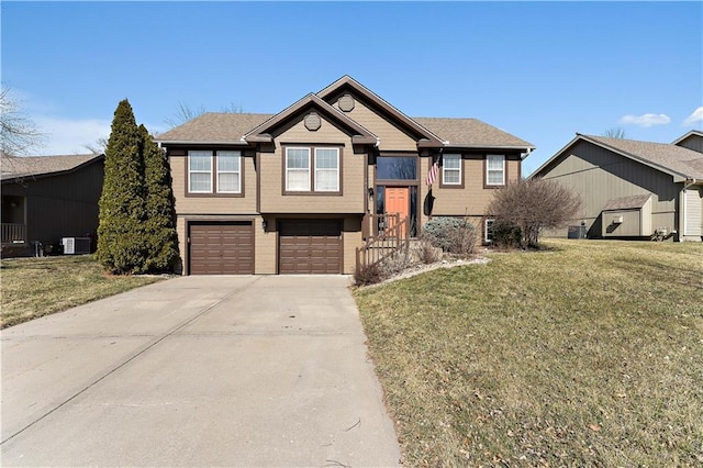 bi-level home featuring central air condition unit, an attached garage, concrete driveway, and a front lawn