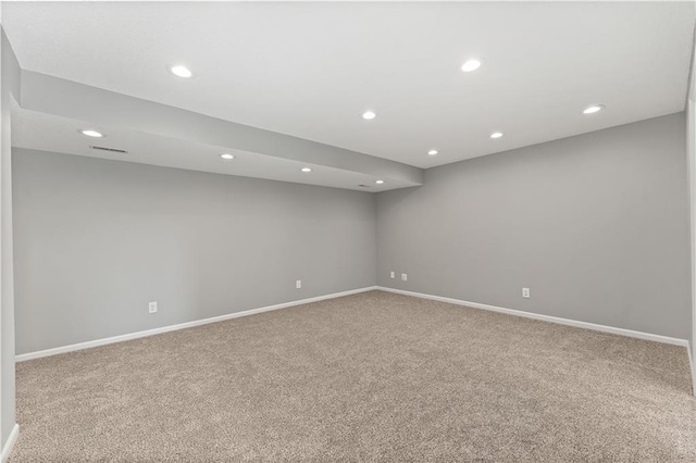 spare room featuring carpet flooring, recessed lighting, and baseboards