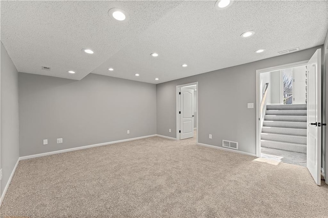 spare room with recessed lighting, visible vents, baseboards, and light colored carpet