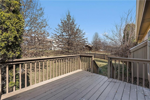 wooden terrace featuring fence