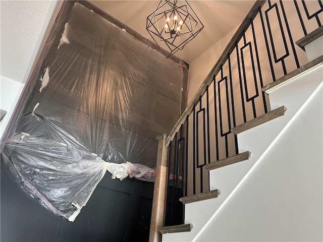 stairs featuring an inviting chandelier