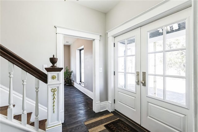 doorway to outside with baseboards, stairway, dark wood-type flooring, and french doors