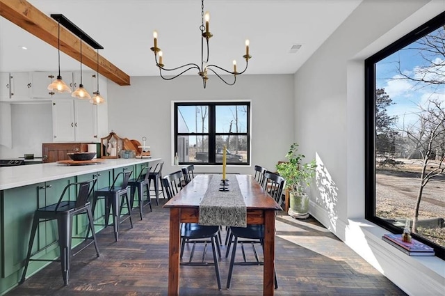 dining space with an inviting chandelier, visible vents, dark wood-type flooring, and beamed ceiling