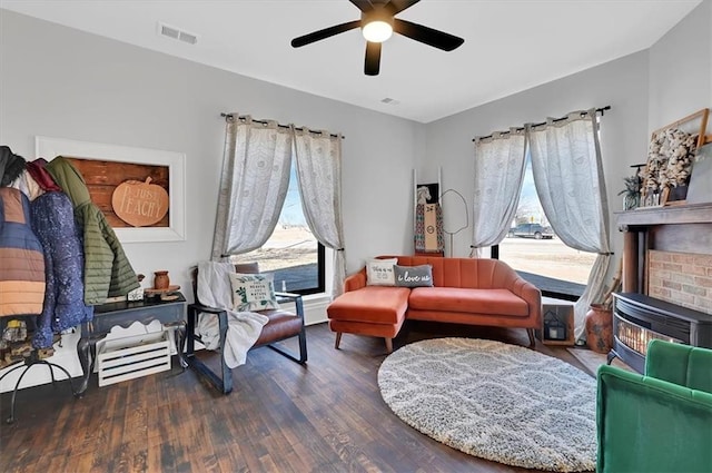 sitting room with ceiling fan, visible vents, and wood finished floors