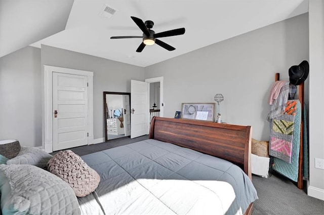 carpeted bedroom with a ceiling fan, visible vents, and baseboards