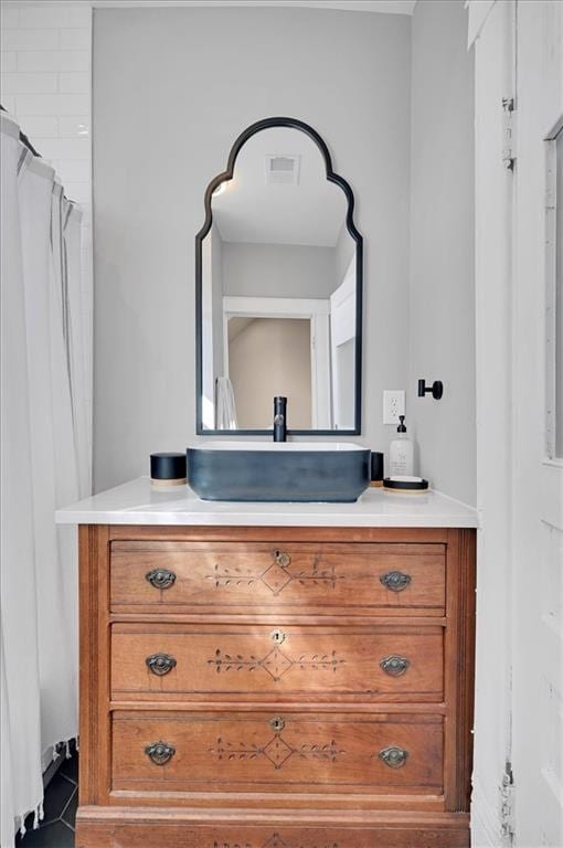 full bathroom featuring tile patterned floors, visible vents, and vanity