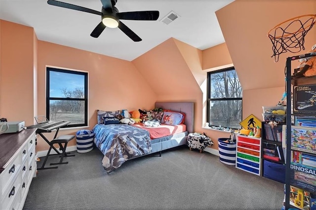 carpeted bedroom featuring baseboards, visible vents, vaulted ceiling, and a ceiling fan