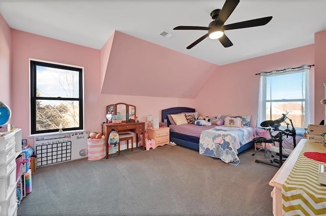 carpeted bedroom featuring visible vents, vaulted ceiling, and a ceiling fan