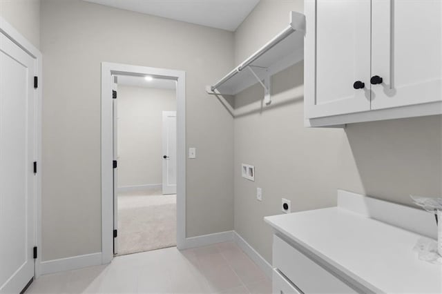 laundry area with hookup for a washing machine, electric dryer hookup, cabinet space, light colored carpet, and baseboards