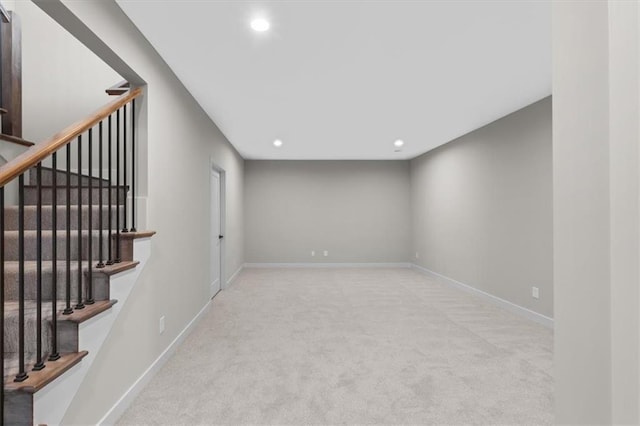 basement featuring baseboards, carpet flooring, recessed lighting, and stairway