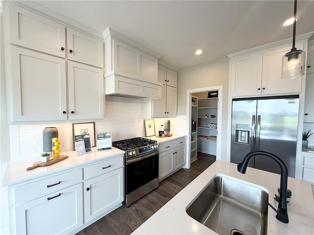 25031 W 94th Ter, Lenexa, KS 66227 - kitchen with stainless steel appliances, a sink, dark wood-style floors, light countertops, and white cabinetry