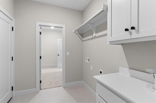 25031 W 94th Ter, Lenexa, KS 66227 - laundry area featuring hookup for a washing machine, electric dryer hookup, cabinet space, baseboards, and light colored carpet