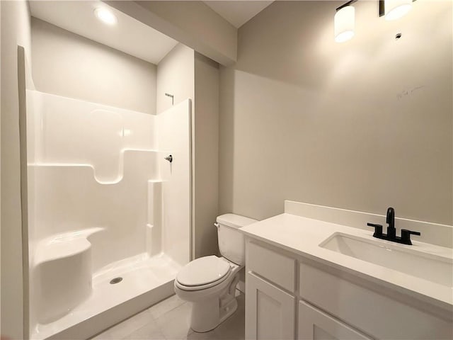 bathroom with toilet, a stall shower, tile patterned flooring, and vanity