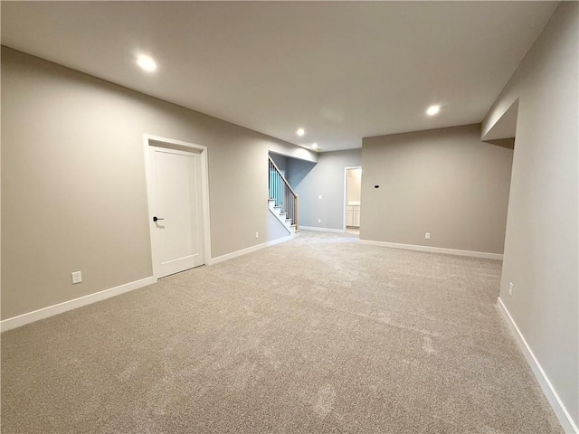 finished basement with recessed lighting, stairway, and baseboards