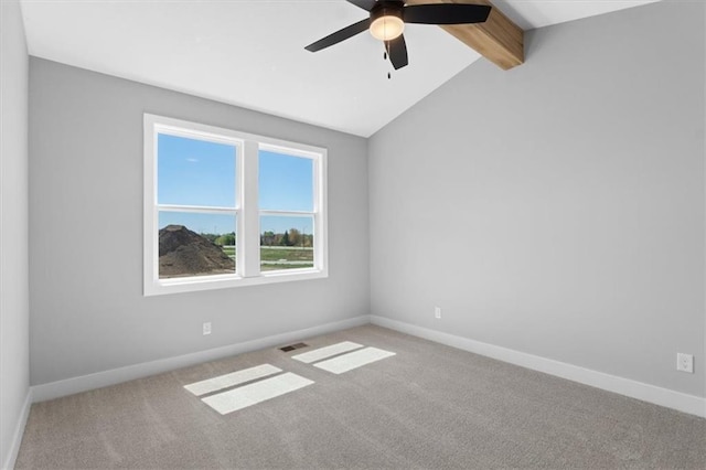 empty room with carpet flooring, ceiling fan, baseboards, and vaulted ceiling with beams