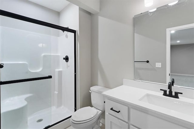 full bath with vanity, a stall shower, and toilet