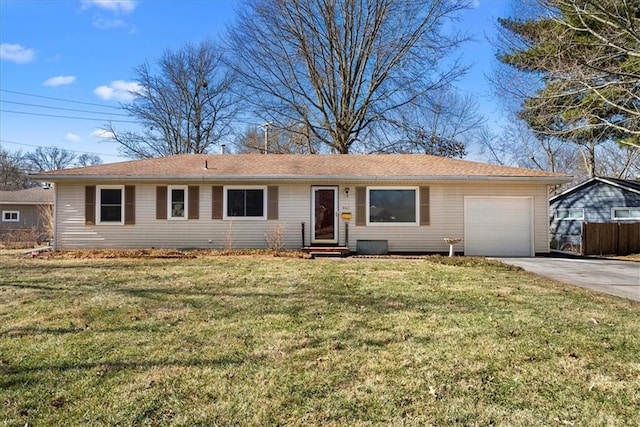 ranch-style home featuring driveway, entry steps, an attached garage, fence, and a front yard