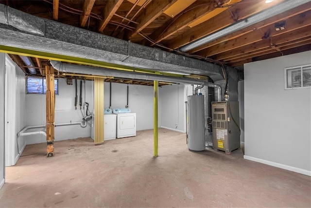 unfinished basement featuring heating unit, washer and dryer, and gas water heater