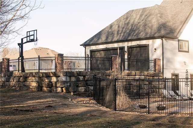 exterior space featuring an attached garage and a fenced front yard