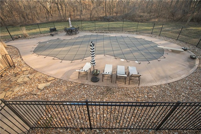 view of pool featuring a patio, fence, and a fenced in pool