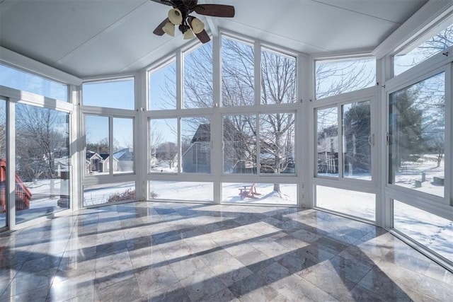 sunroom / solarium featuring ceiling fan and a healthy amount of sunlight