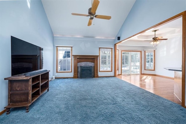 unfurnished living room featuring ceiling fan, high vaulted ceiling, a fireplace, and baseboards