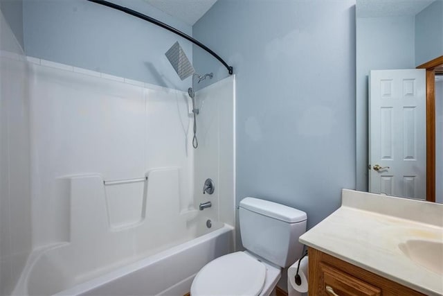 bathroom featuring washtub / shower combination, a textured ceiling, vanity, and toilet