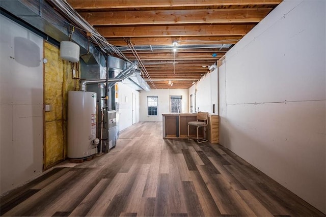 below grade area featuring dark wood-style floors and gas water heater