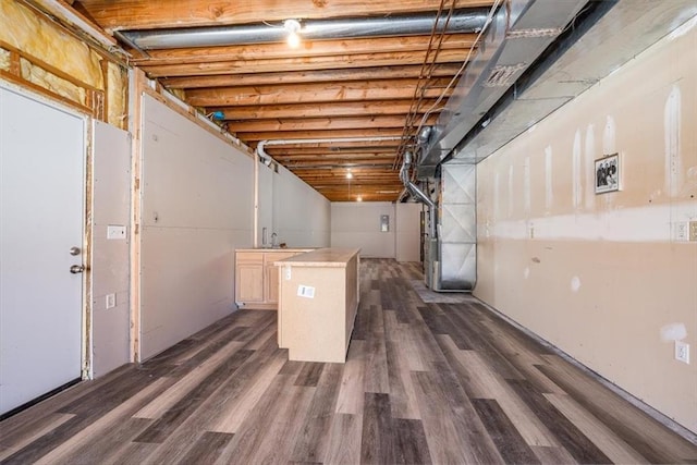 basement with a garage and dark wood-type flooring