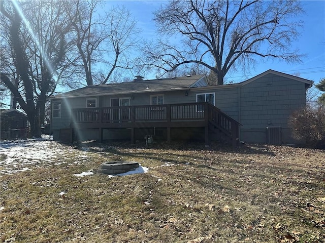 rear view of house featuring an outdoor fire pit and a wooden deck