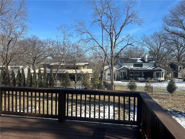 snow covered deck with a residential view and fence private yard