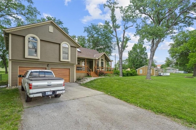 view of front facade featuring brick siding, a porch, concrete driveway, an attached garage, and a front yard