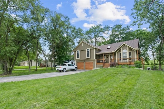 view of front facade with covered porch, aphalt driveway, a front yard, and a garage